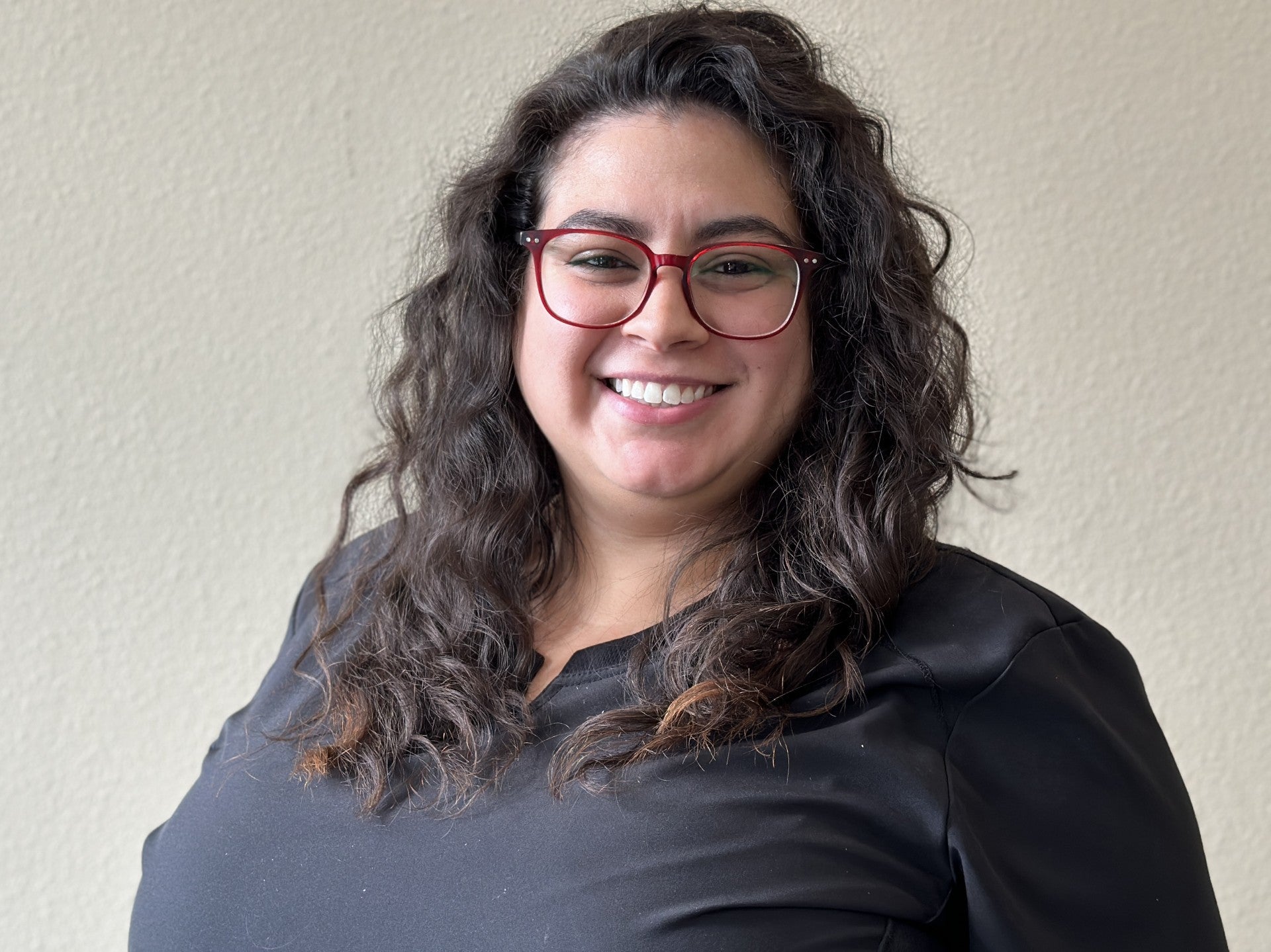 Team member looking at the camera and smiling