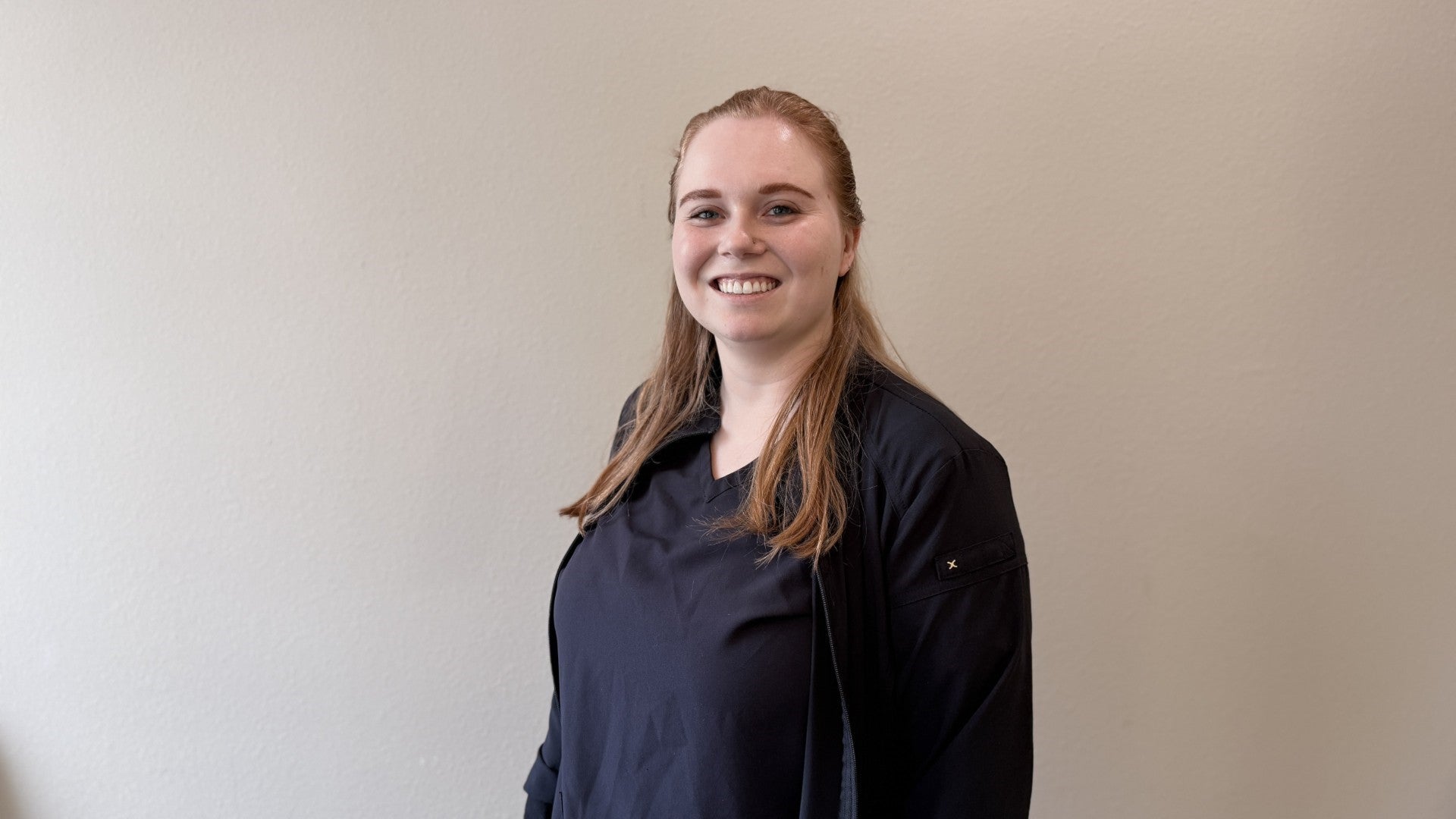 Team member looking at the camera and smiling